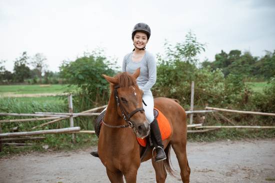 girl on horse in riding arena